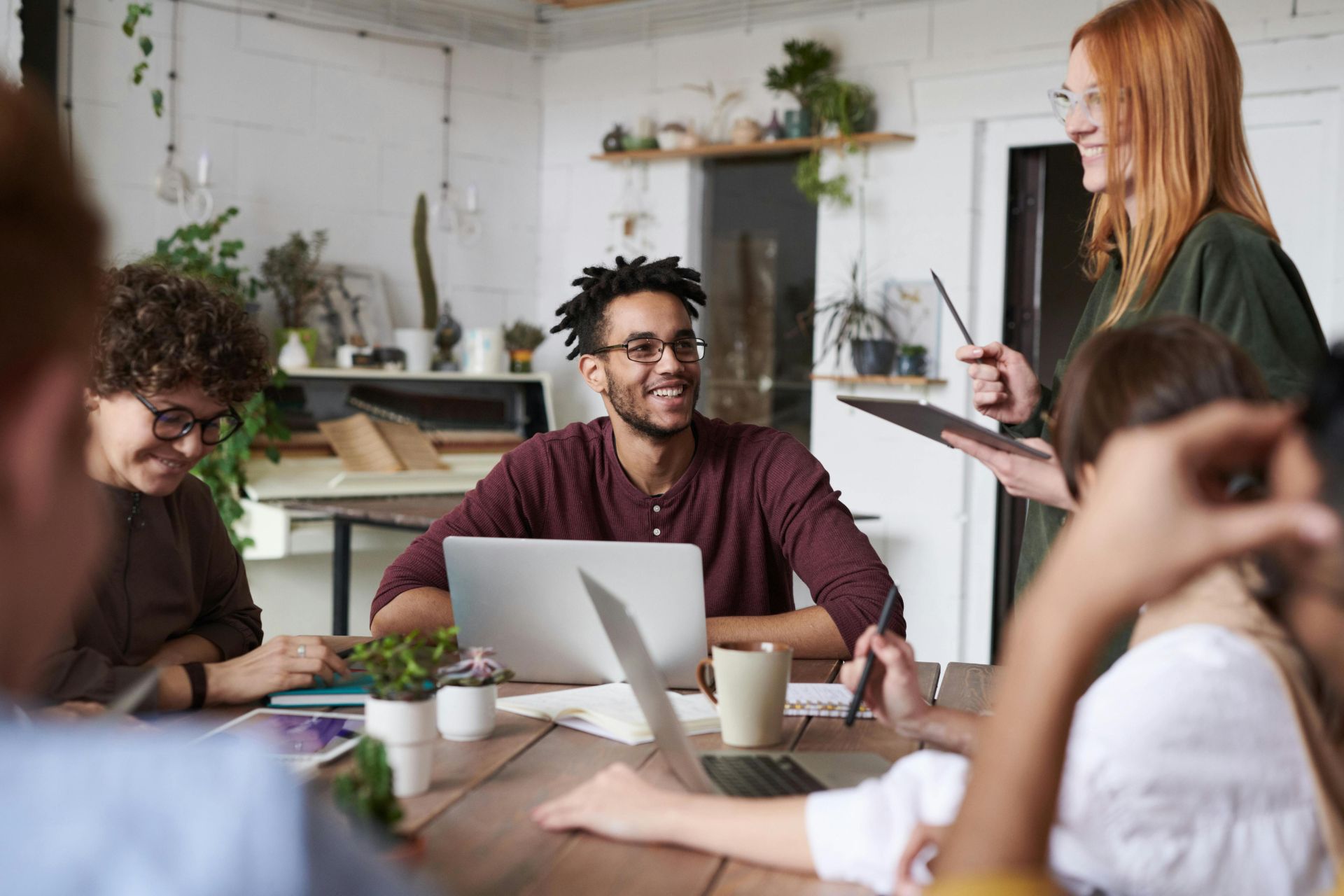 A diverse group of professionals engaging in a productive team meeting in a modern office space.